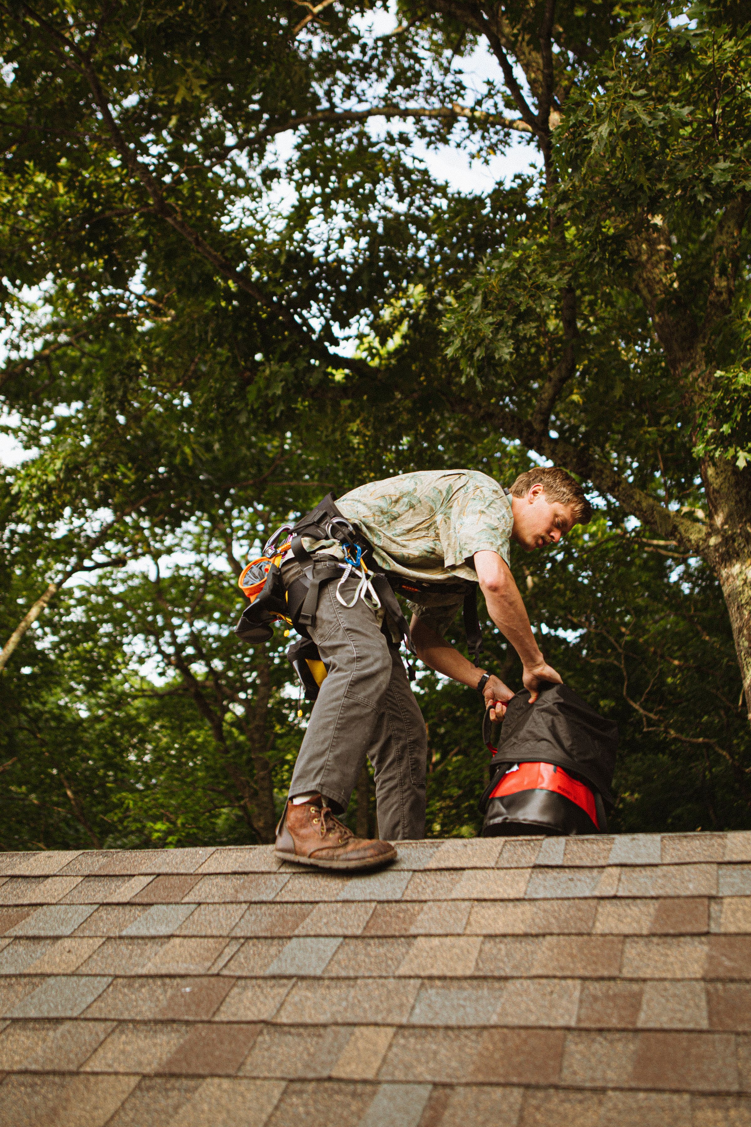 Roofer working along the ridge of the new roof