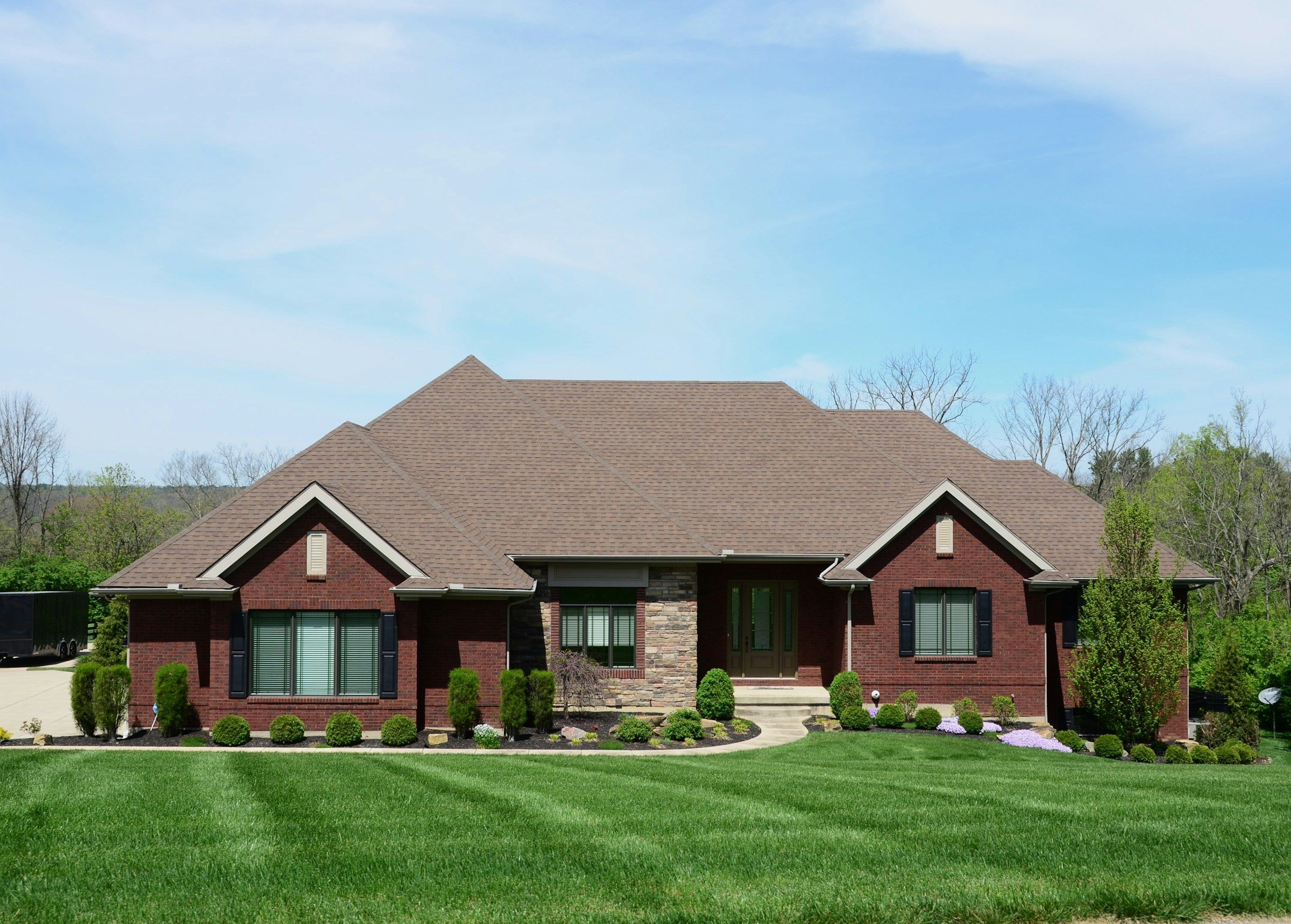 Brick ranch house with a finished new roof and a clean lawn